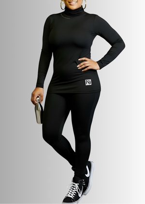 Woman wearing a black turtleneck and leggings with a visible brand logo on a gray background