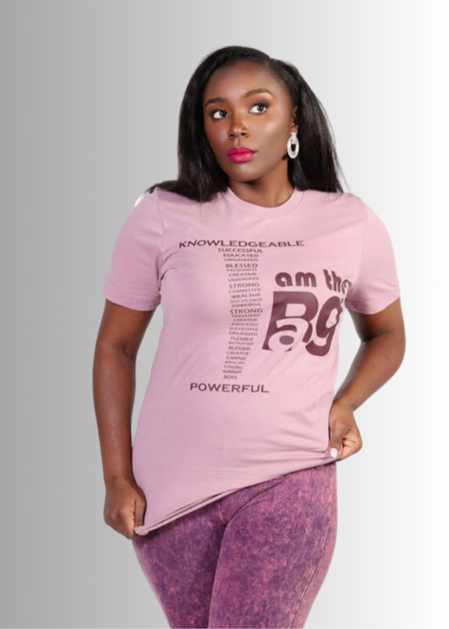 Woman wearing a royal unisex "I AM THE BAG" pink t-shirt with bold graphic text and comfortable fit.