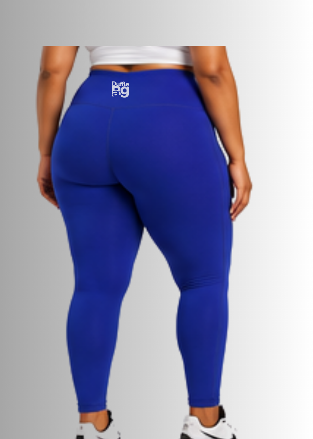 Person wearing #CobaltBlue
 Duffle Bag leggings with a visible brand logo on a gray background