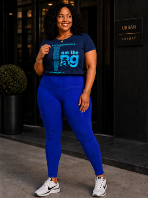 Woman wearing a #CobaltBlue
Duffle Bag leggings with I AM The bag tshirt, standing in front of a building entrance.