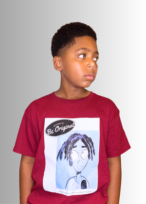 Boy wearing a maroon Be Original Color Kids T-Shirt with a cartoon face design on the front.
