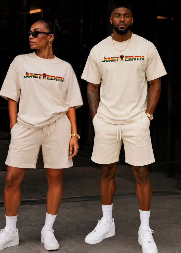 Two people wearing matching beige Juneteenth shirts 
