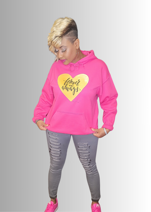Love Gold Heart hoodie with gold heart design, pink color, worn with ripped jeans.