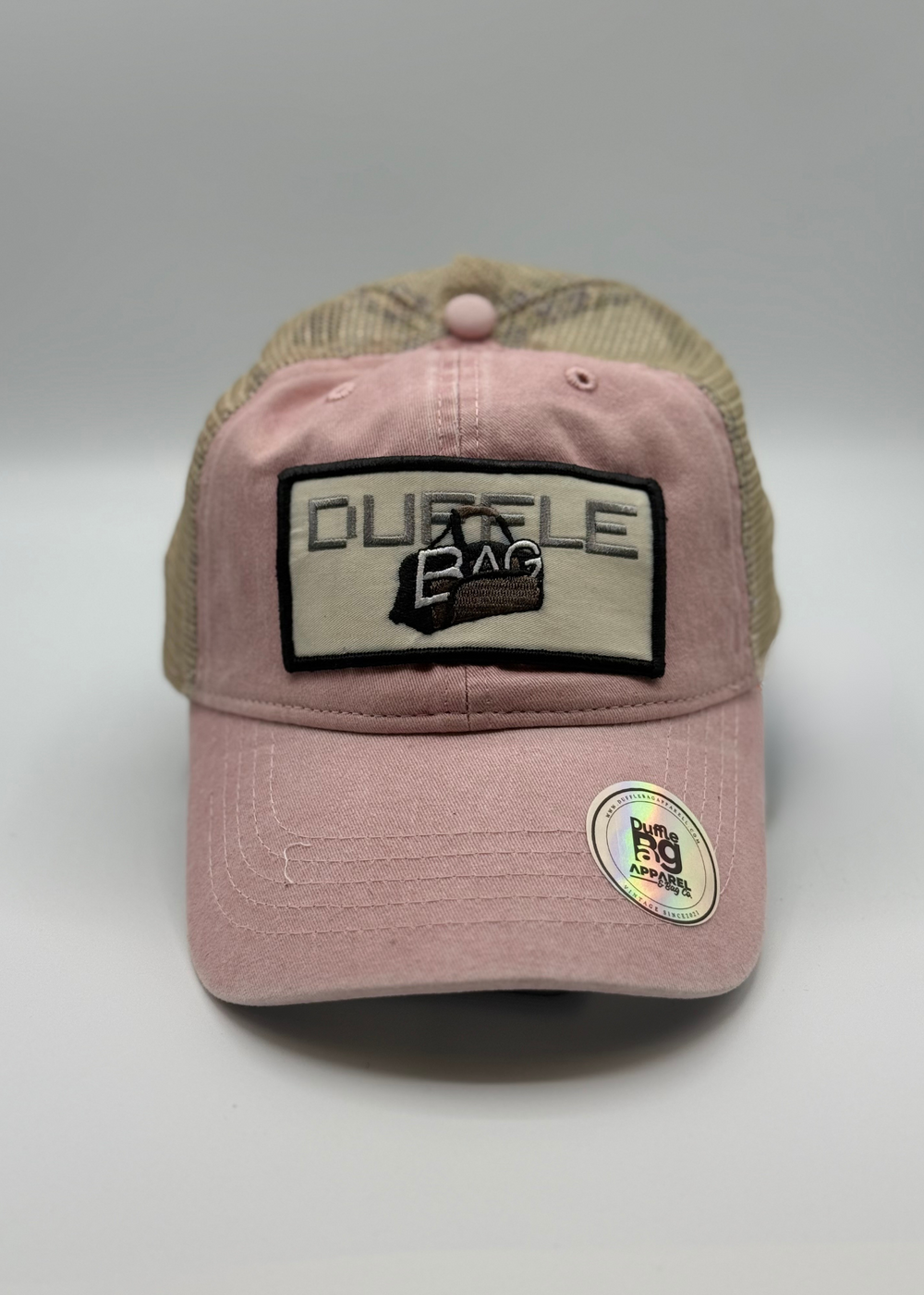 Pink Petal Trucker Hat with Duffle Bag logo, blush pink front, tan mesh back, floral print underbrim.