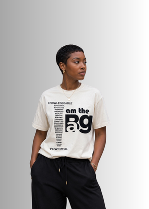 Person wearing a cream I AM The Bag  t-shirt By Duffle Bag Apparel gray background
