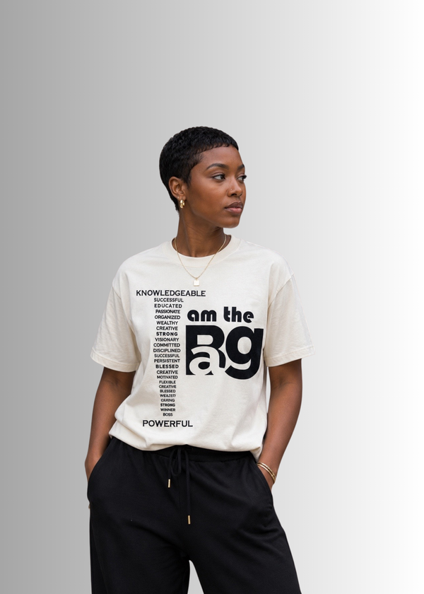 Person wearing a cream I AM The Bag  t-shirt By Duffle Bag Apparel gray background