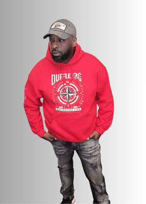 Man wearing red N.A.V Empowerment Hoodie by Duffle Bag with compass design.
#red